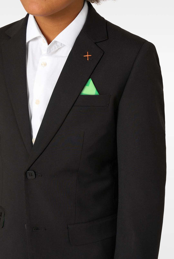 Close-up of the blazer chest area with a green pocket square and an orange stitch detail near the lapel.