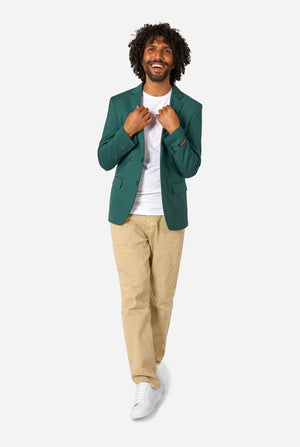 Man wearing a green blazer, white shirt, beige pants, and white shoes on a white background