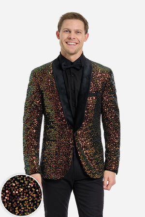 Man wearing a orange sequin blazer over a black pants and white shirt on a light background. Close-up in left corner.