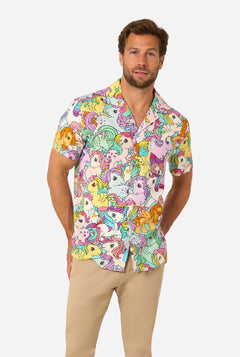 Man wearing a colorful My Little Pony shirt with cartoon character pattern on a white background