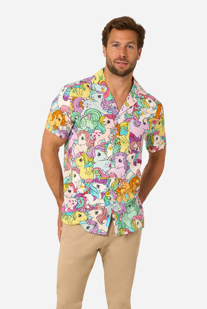 Man wearing a colorful Hawaiian shirt with My Little Pony character pattern on a light background.
