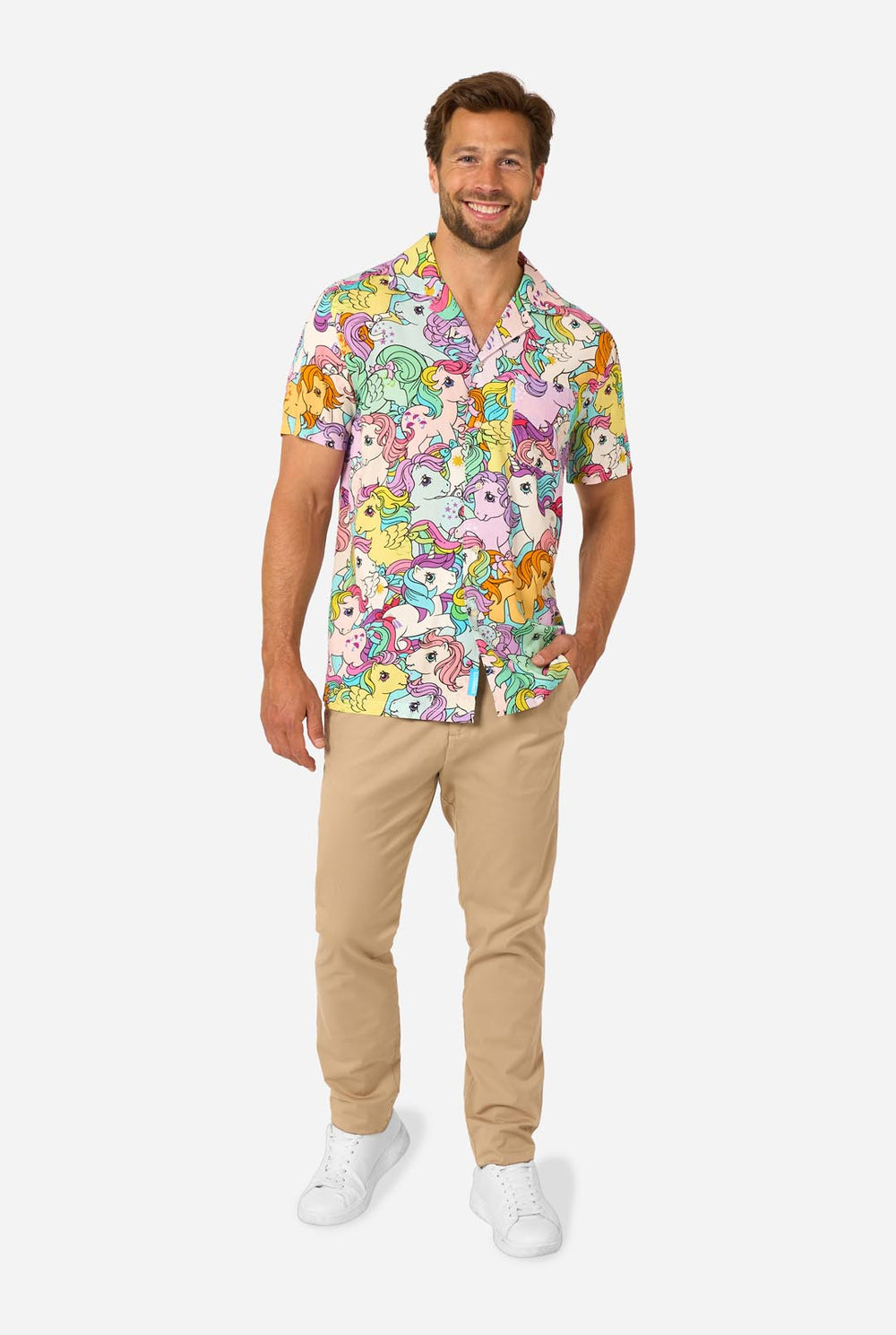 Man wearing a colorful Hawaiian shirt with My Little Pony character pattern on a light background.
