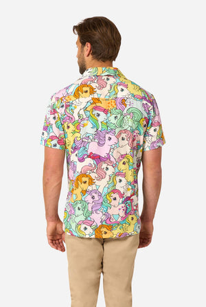 Man wearing a colorful Hawaiian shirt with My Little Pony character pattern on a light background. View from the back.