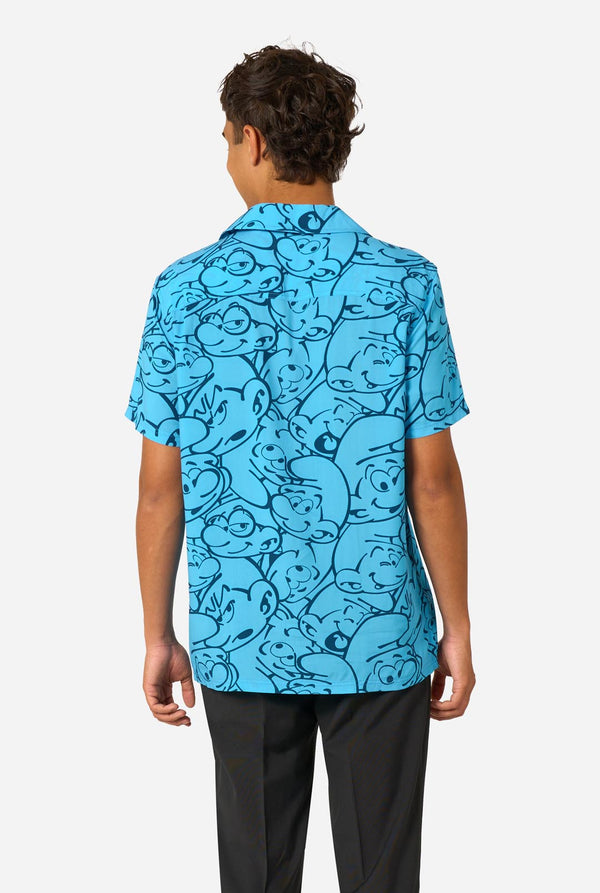 Person wearing a blue 'The Smurfs' themed shirt on a light background. View from the back.