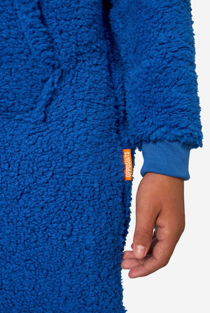 A kid is wearing a blue sesame street onesie resembling Cookie Monster. Close up sleeve.