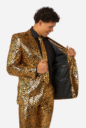 Men wearing golden suit with star print, holding one side of the jacket open.