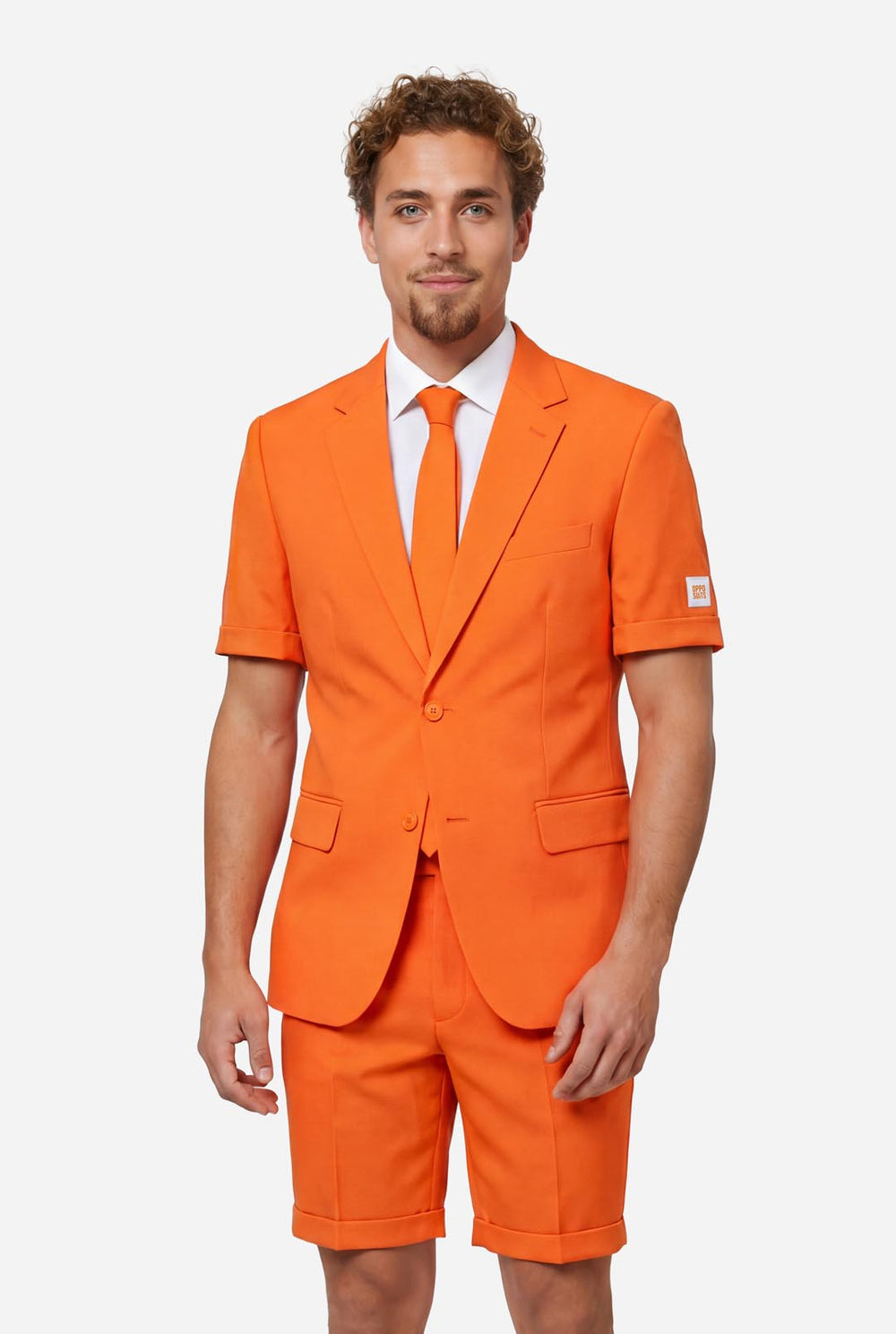 Man wearing an orange summer suit with matching tie on a light background