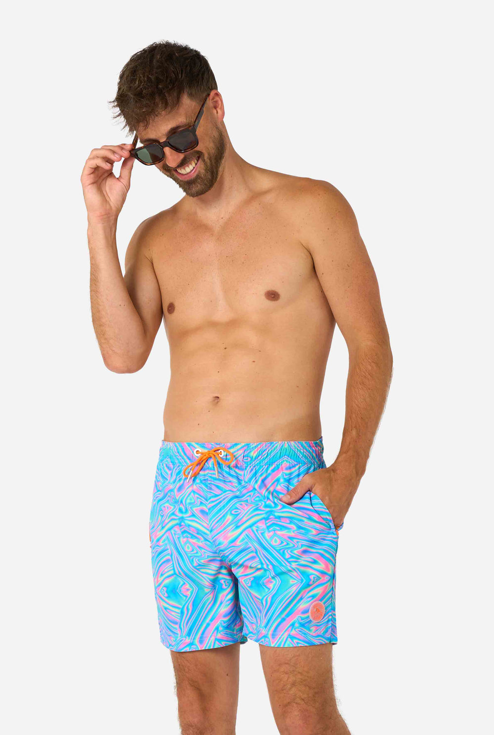 Man wearing a men's vibrant holographic swim shorts with a mesmerizing blue, pink, and purple swirl design. Eye-catching and stylish swimwear for summer fun. Closeup of his middle.