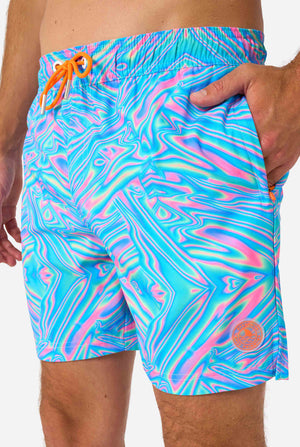 Man wearing a men's vibrant holographic swim shorts with a mesmerizing blue, pink, and purple swirl design. Eye-catching and stylish swimwear for summer fun. Close up front.