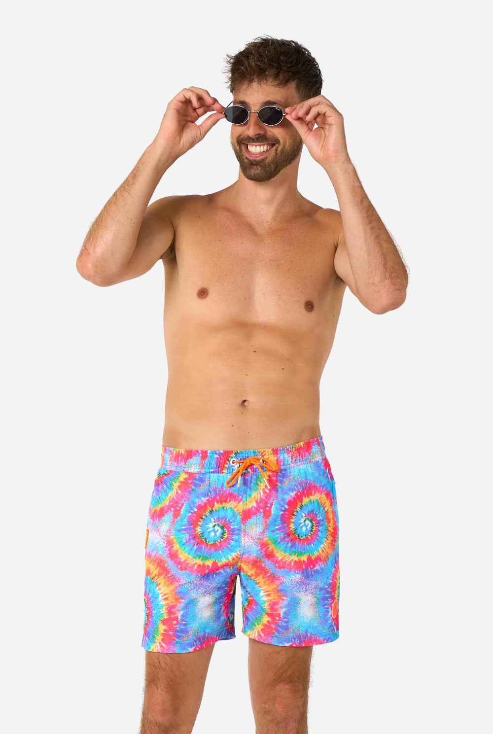 Man wearing a men's rainbow tie-dye swim shorts with a bold, colorful spiral pattern. A fun and trendy choice for beach days and pool parties. Close-up middle.