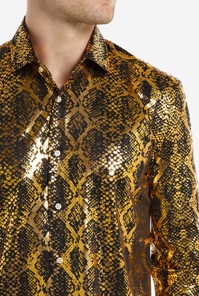 This image showcases a men’s dress shirt from OppoSuits, featuring a striking gold and black snakeskin print pattern. The shirt’s fabric has a glossy finish that reflects light, creating a bold, high-fashion look perfect for making a statement. With a detailed reptile-inspired pattern, this shirt is ideal for anyone looking to bring some edgy style to their wardrobe. Close-up.