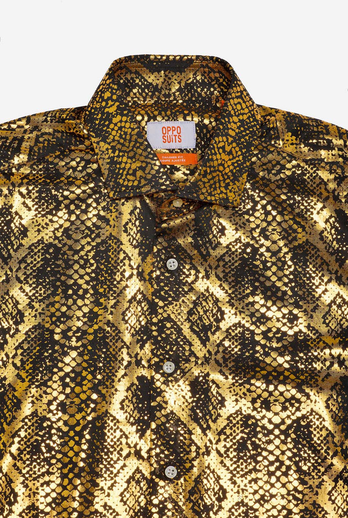 This image showcases a men’s dress shirt from OppoSuits, featuring a striking gold and black snakeskin print pattern. The shirt’s fabric has a glossy finish that reflects light, creating a bold, high-fashion look perfect for making a statement. With a detailed reptile-inspired pattern, this shirt is ideal for anyone looking to bring some edgy style to their wardrobe. Close-up.