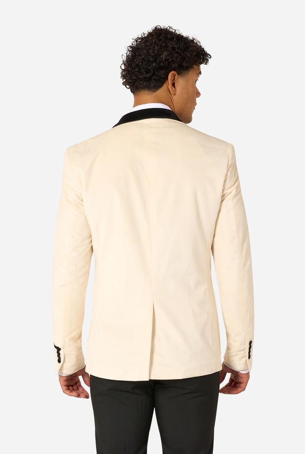 Man wearing a cream blazer with black lapels and cuffs on a light background. View from the back.