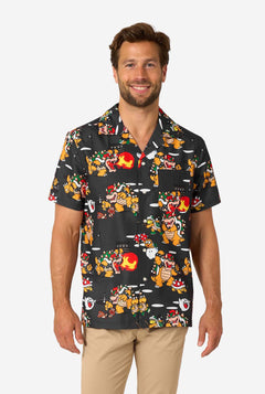 Man wearing a black Hawaiian shirt with colorful Bowser character print on a white background