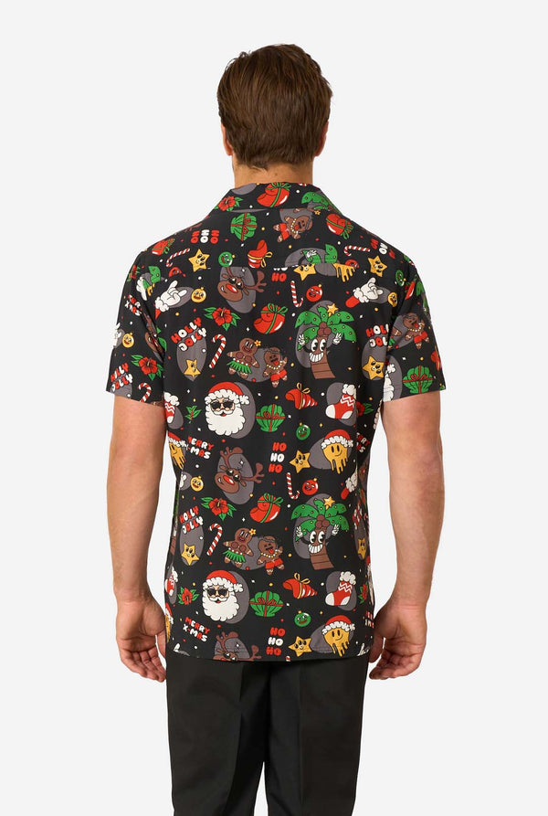 Person wearing a black short-sleeve Christmas shirt with colorful Christmas-themed graphics on a white background