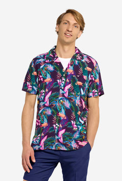 Man wearing a colorful floral shirt with a white background
