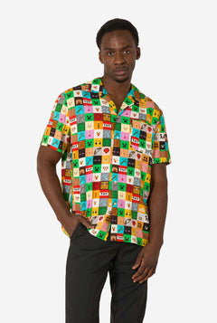Man wearing a colorful patterned Minecraft shirt on a white background