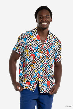 Man wearing a colorful patterned Sonic shirt with a checkered design on a white background