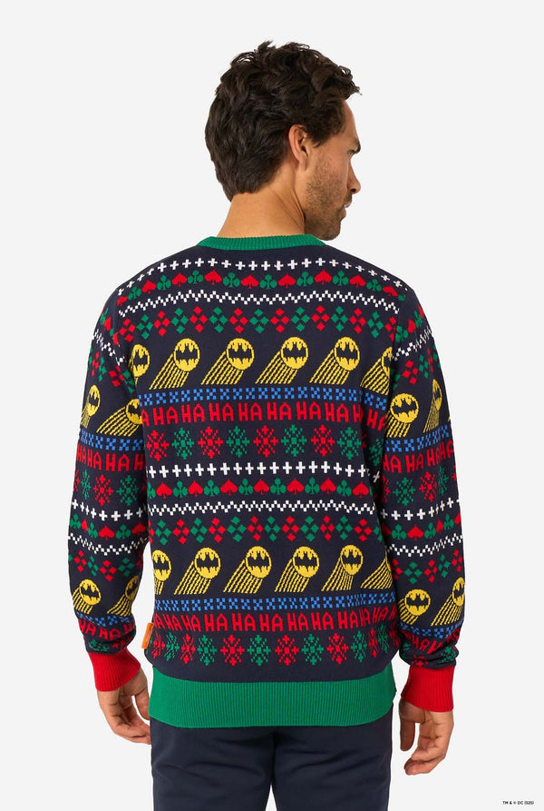 Back view of the knitted Christmas sweater with repeated Batman symbols and festive “Ha Ha Ha” patterns.