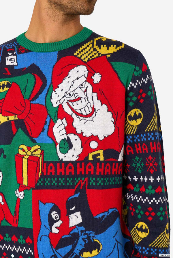 Close-up of the knitted Christmas sweater showing Batman, a grinning Santa figure, and gift box designs.