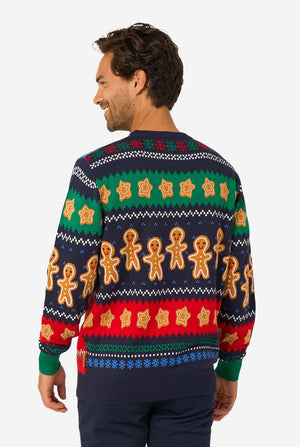 Back view of a knitted Christmas sweater decorated with rows of gingerbread men and star-shaped cookies in festive colors.