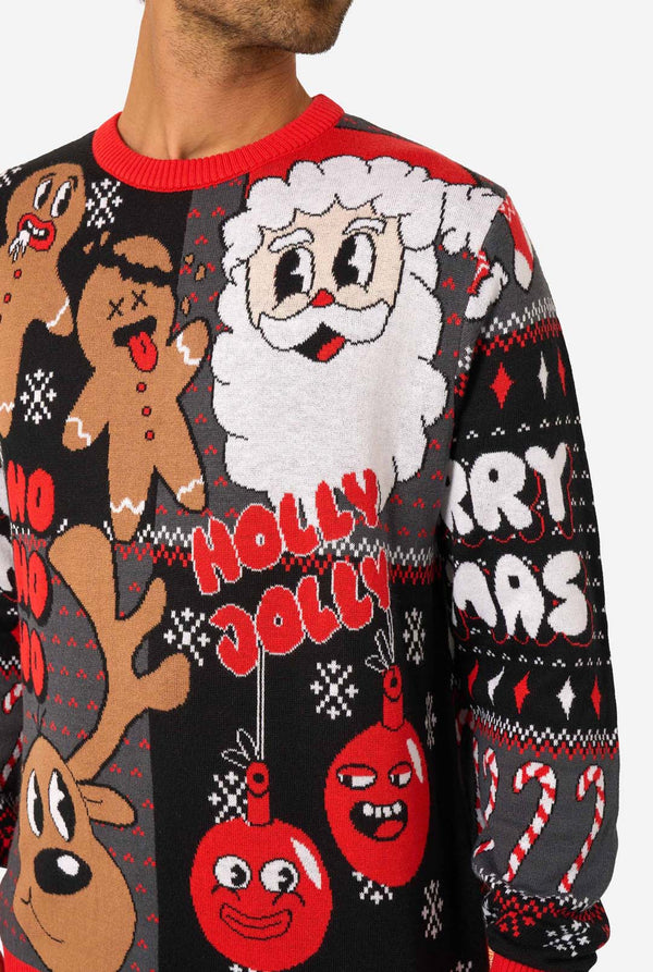 Close-up of the knitted Christmas sweater showing Santa, gingerbread men, reindeer, and red ornaments with “Holly Jolly” text.