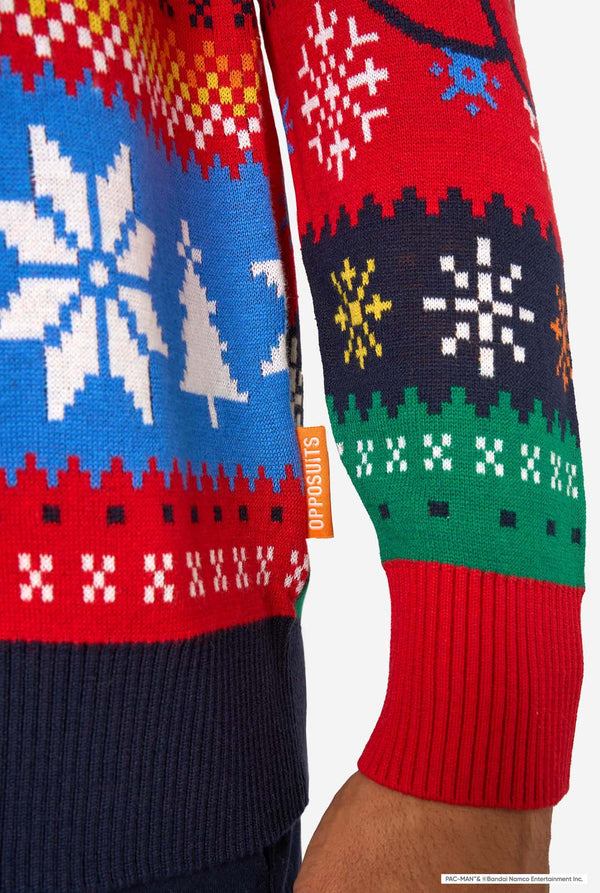 Detail of the knitted Christmas sweater hem with multicolored festive patterns and an orange “Opposuits” label.