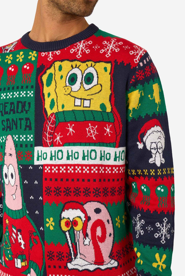 Close-up of the knitted Christmas sweater showing SpongeBob, Patrick, and a snail character in Christmas outfits.