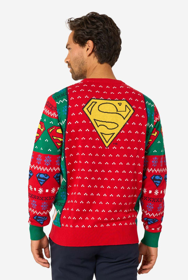Back view of the knitted Christmas sweater with a large yellow Superman logo and festive red pattern.