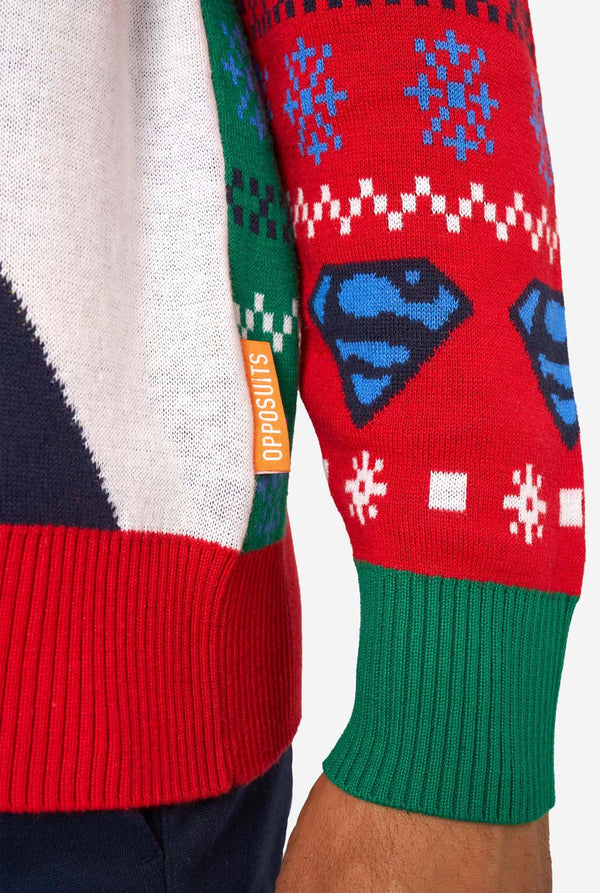 Detail of the sweater’s sleeve with blue Superman logos, snowflakes, and an orange “Opposuits” label.