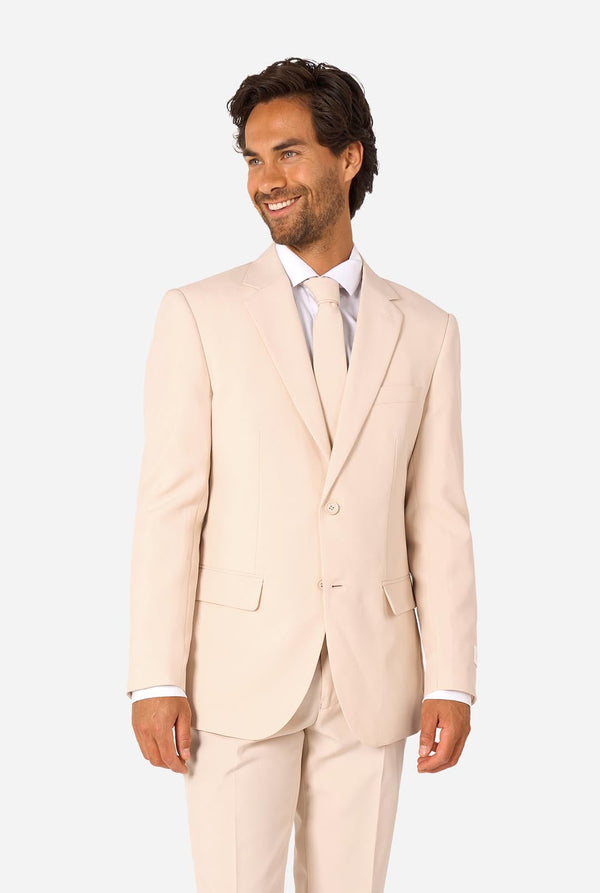 Image of a man wearing a sand colored beige suit and a white shirt.