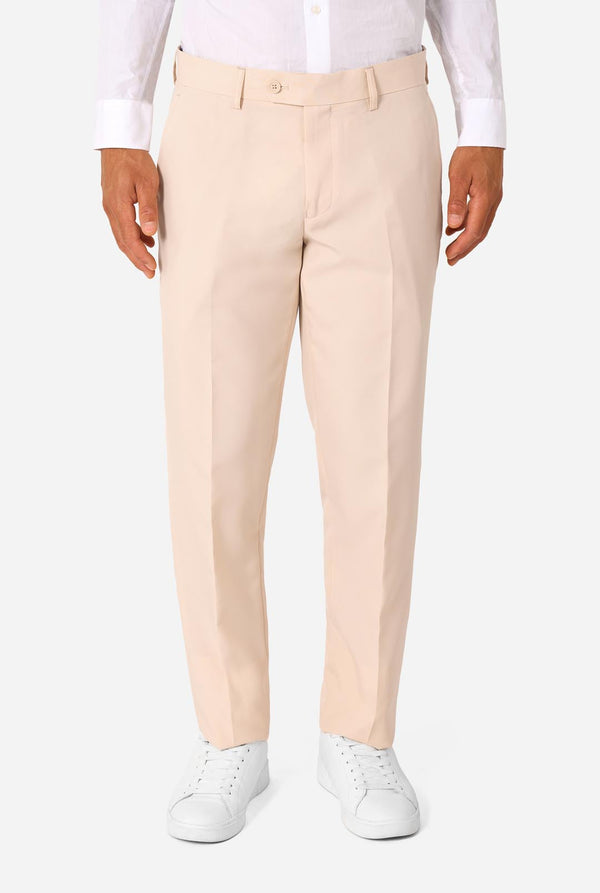 Image of a man wearing a sand colored beige suit and a white shirt. Close-up of the pants.