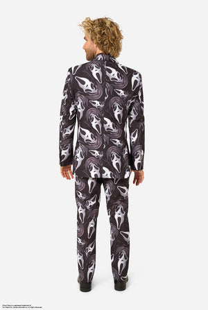 A man modeling a Ghostface-themed suit with a black, white, and gray mask pattern, a black shirt, a bow tie. View from the back.