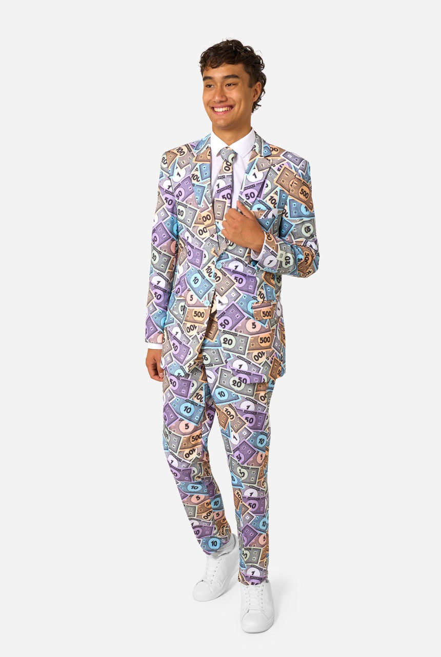 Image of a man wearing a men's suit with an all over print from Monopoly money. He is also wearing a white men's shirt.