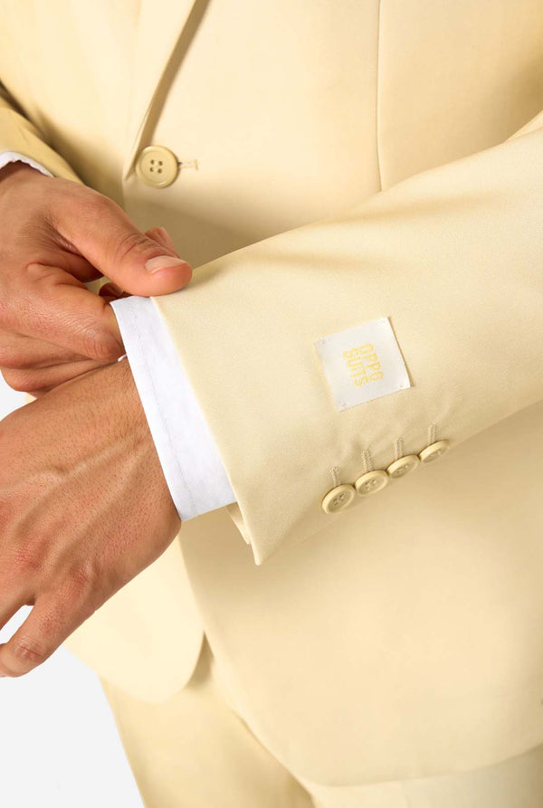 Elegant men's suit in a soft pastel yellow shade, perfect for weddings, summer events, and formal occasions. This stylish tailored suit features a slim fit design, notch lapels, and a matching tie for a sophisticated look. Ideal for modern gentlemen looking to make a statement with a light-colored pastel suit. Sleeve close up.