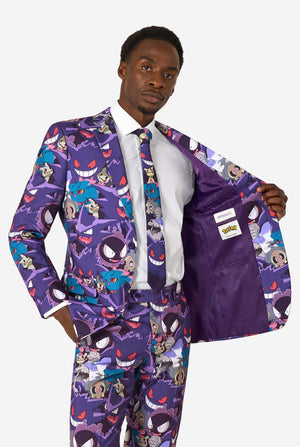 A man wearing a Ghost Pokemon themed suit with a Ghost Pokemon themed tie and a white shirt on a white background. Holding his jacket open