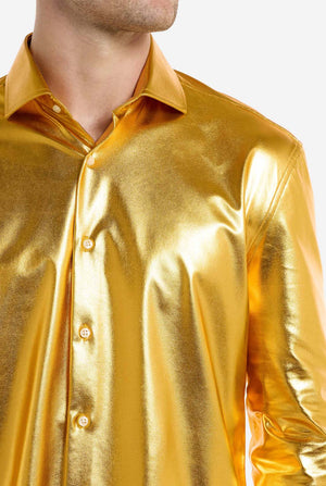 Gold metallic shirt worn by a person on a white background, close up.