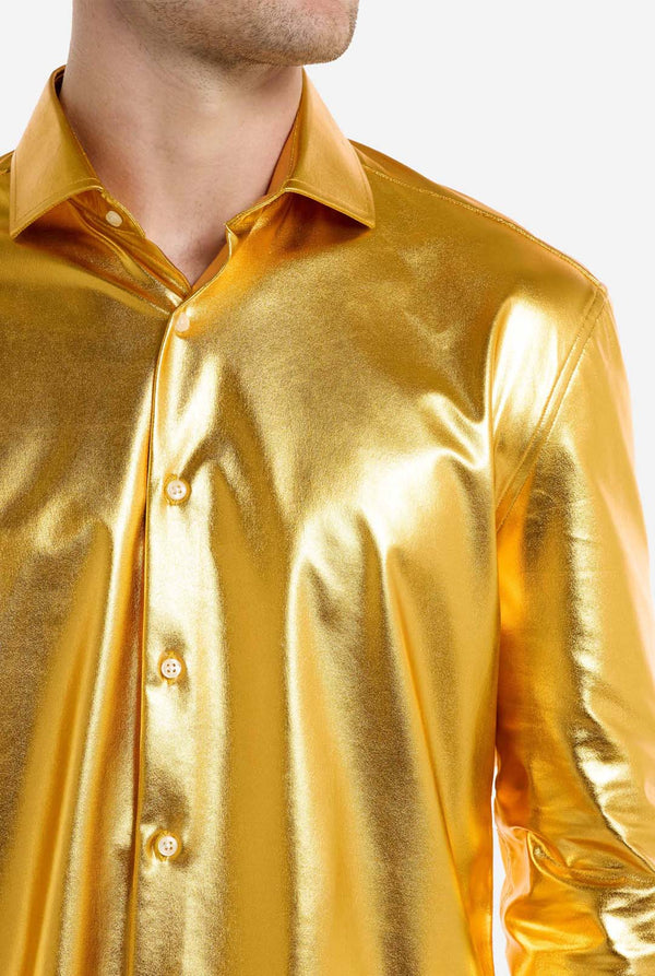 Gold metallic shirt worn by a person on a white background, close up.