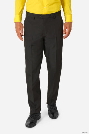 Front view of black suit trousers worn with a yellow shirt and black dress shoes on a white background.