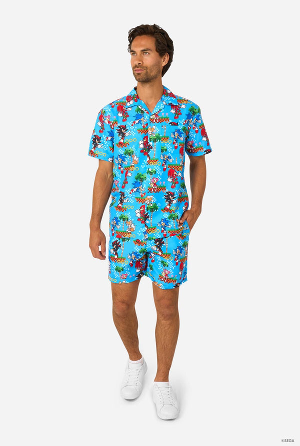 Image of a man wearing a blue summer set with Sonic, Tails, Knuckles, and Shadow game print. Full body image.
