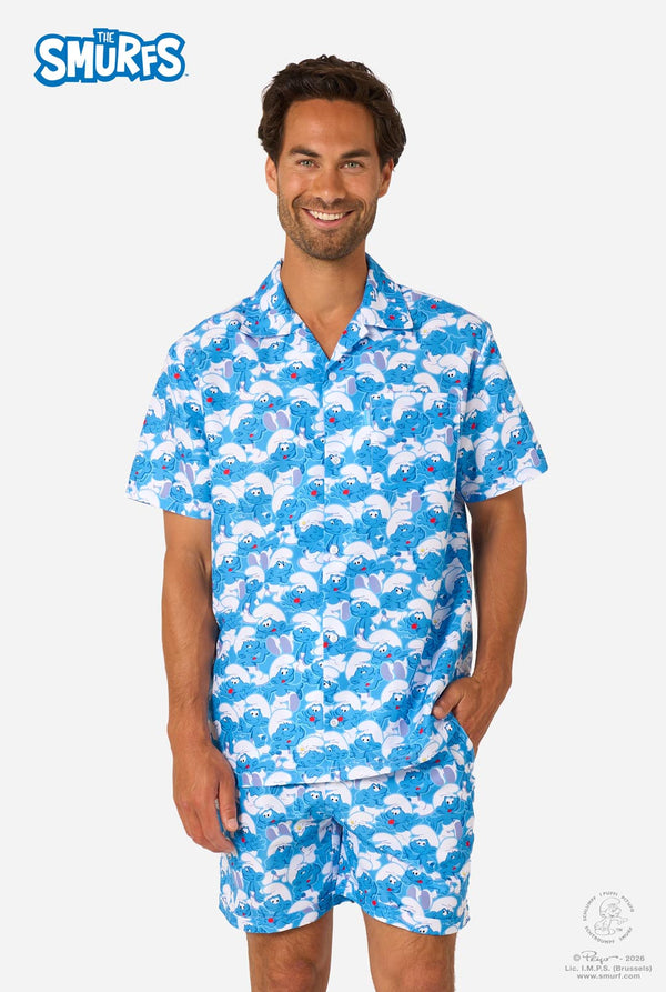 Man wearing a blue and white patterned Smurfs summer set with 'The Smurfs' logo.