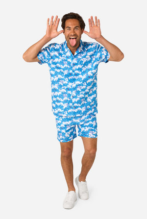 Man wearing a blue and white Smurfs patterned shirt and shorts on a light background. Full body image 2.