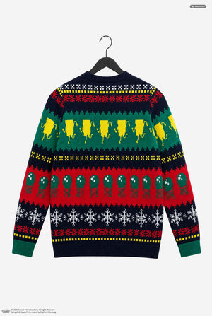A festive Christmas sweater displayed on a black hanger against a light gray background. The back of the long-sleeve knit sweater features a multi-colored holiday pattern with rows of yellow lemons, green olives, red peppers, and white snowflakes on a dark navy base.