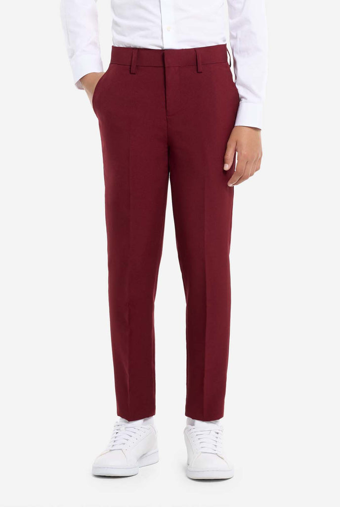 Teen wearing formal burgundy red suit, pants view