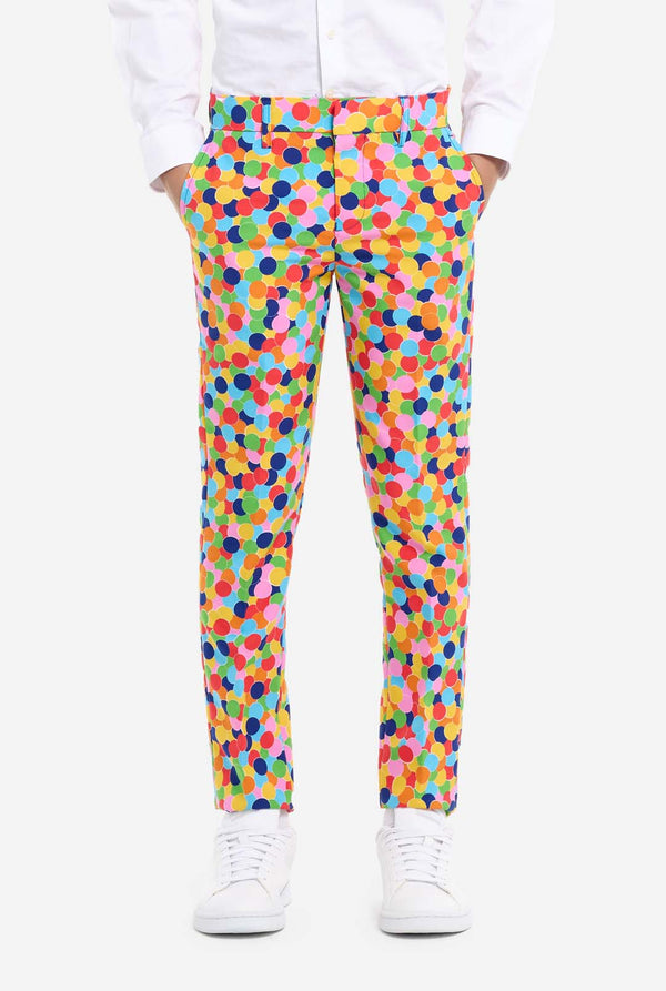 In this image, a kid is wearing a colorful, polka-dotted suit. The suit has a bright pattern with circles in various colors including orange, yellow, pink, green, blue, and red, arranged in a confetti-like style. Pants view.