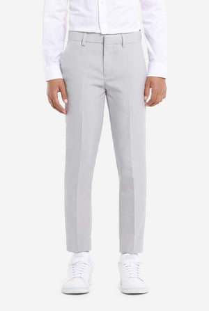 In this image, a kid is wearing a formal grey suit. The suit consists of a blazer, pants and tie. Pants view