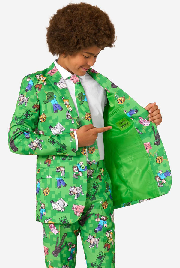 A teen boy wearing a bright green Minecraft suit with iconic characters, including Creepers and Steve - Holding his jacket open