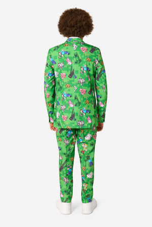 A teen boy wearing a bright green Minecraft suit with iconic characters, including Creepers and Steve - View from the back