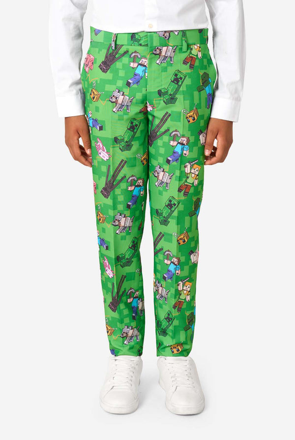 A teen boy wearing a bright green Minecraft suit with iconic characters, including Creepers and Steve - Close up of the pants