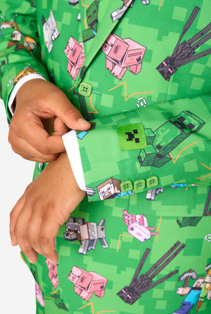 A teen boy wearing a bright green Minecraft suit with iconic characters, including Creepers and Steve - Close up of the sleeves